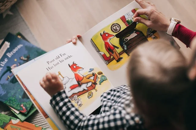 Child reading a story book.